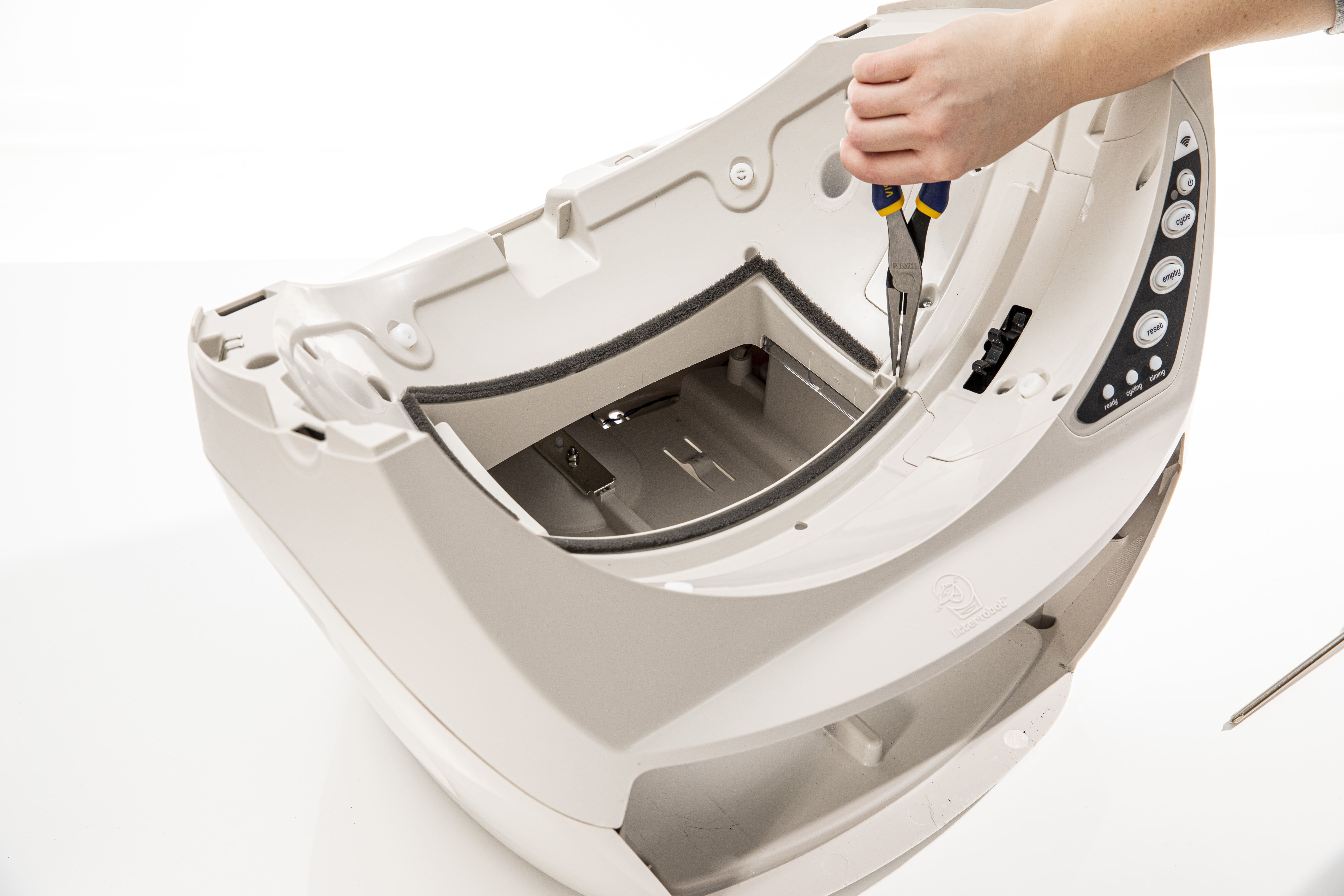 Lifting the control panel cover with pliers