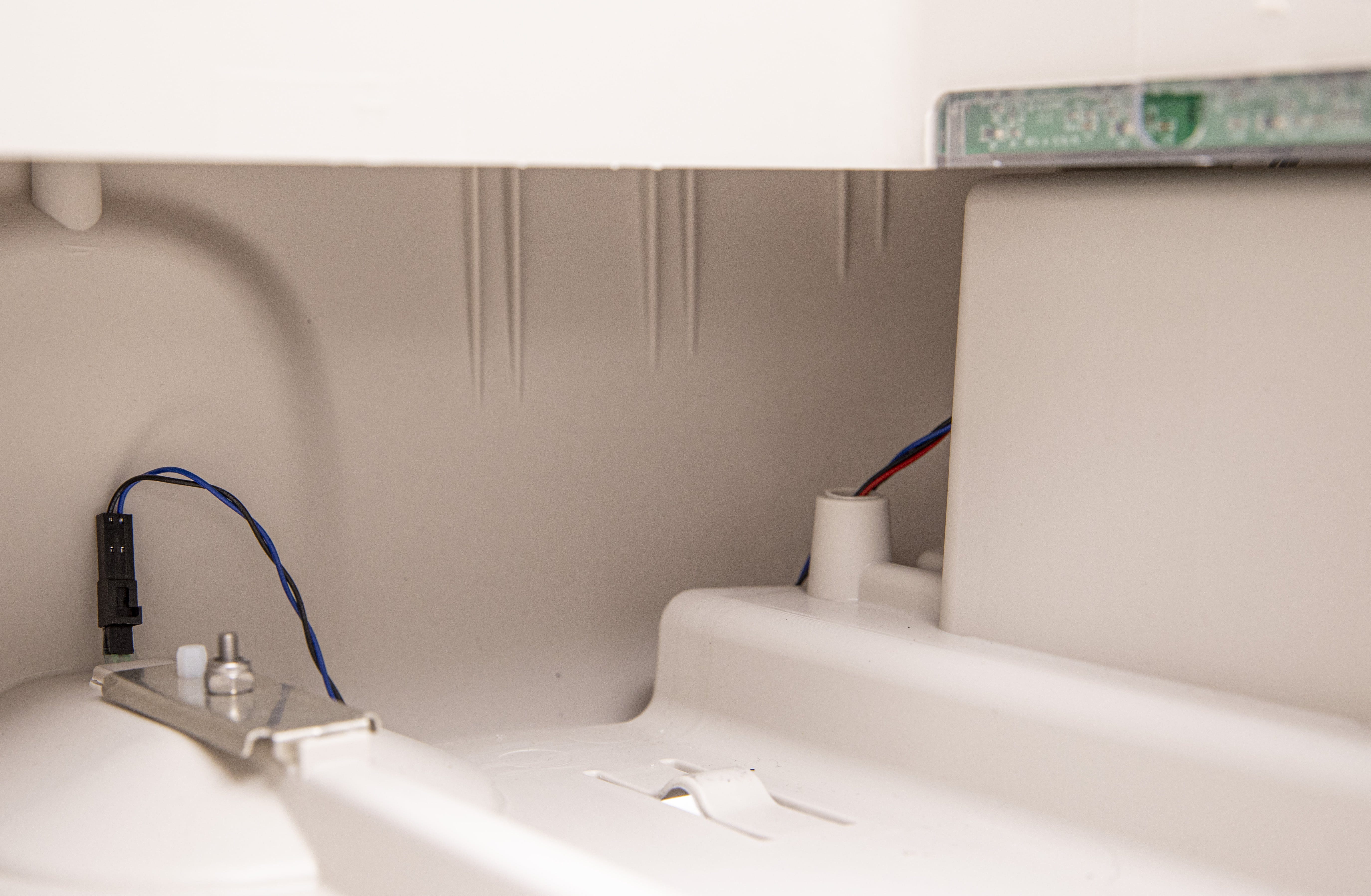 Checking wire routing near waste drawer opening