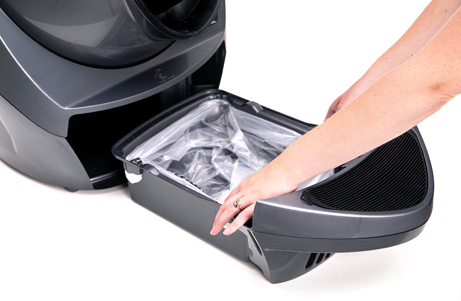 Pushing the remainder of the bag into the bottom of the Litter-Robot 3 Waste Drawer and then sliding the waste drawer closed.