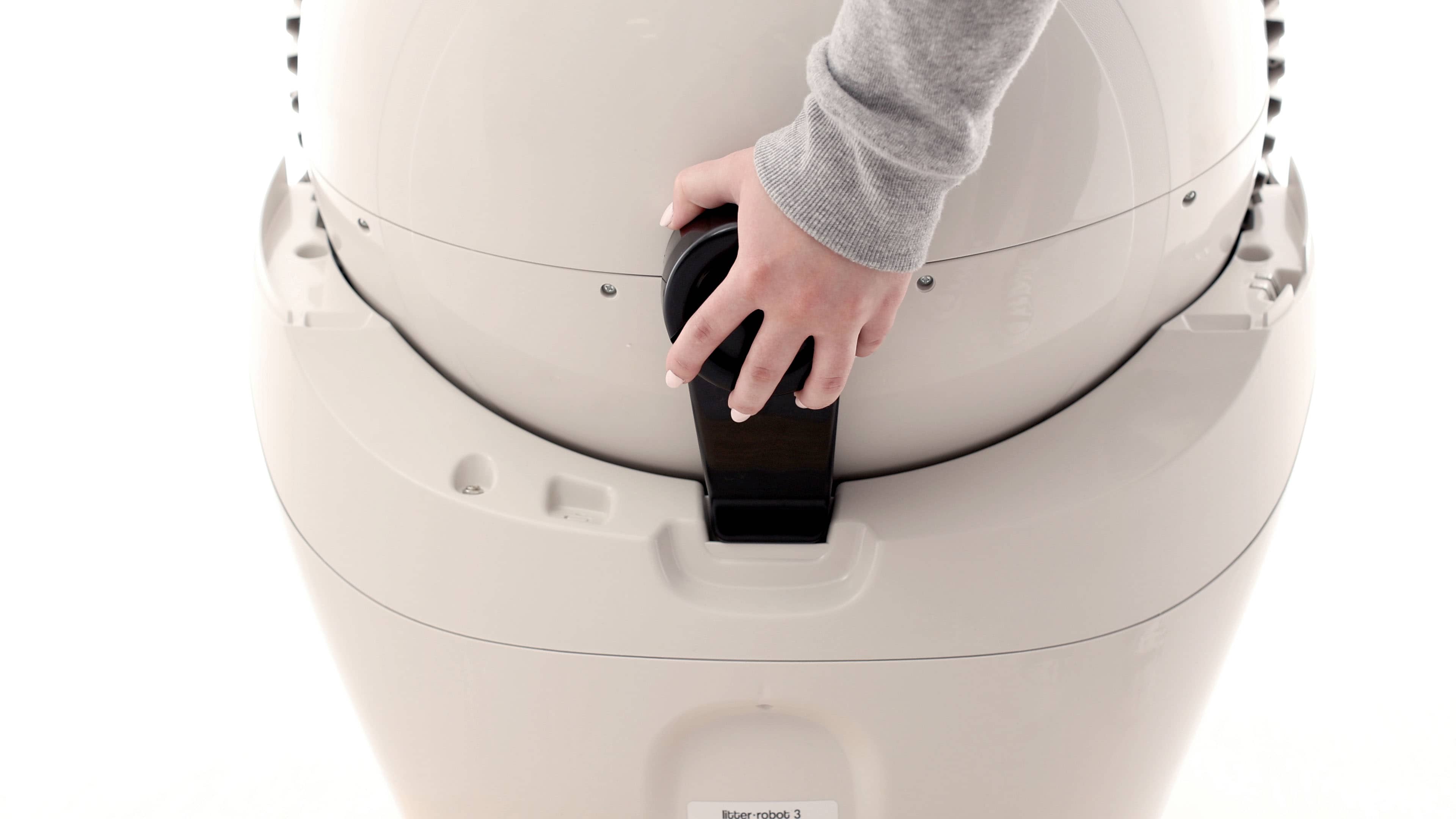 placing Litter-Robot 3 black key into the key pocket