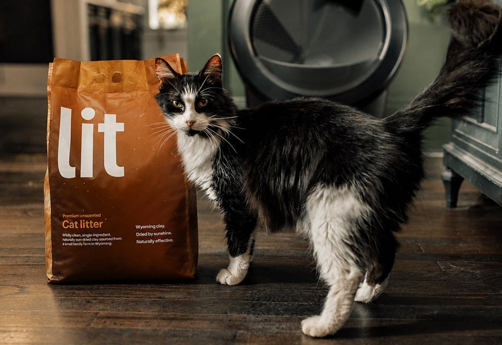 Bag of cat litter with black and white cat